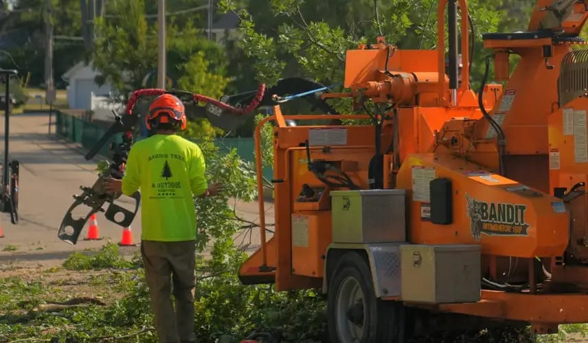 Team operating chipper for shrub trimming & removal services in Southeastern Wisconsin.